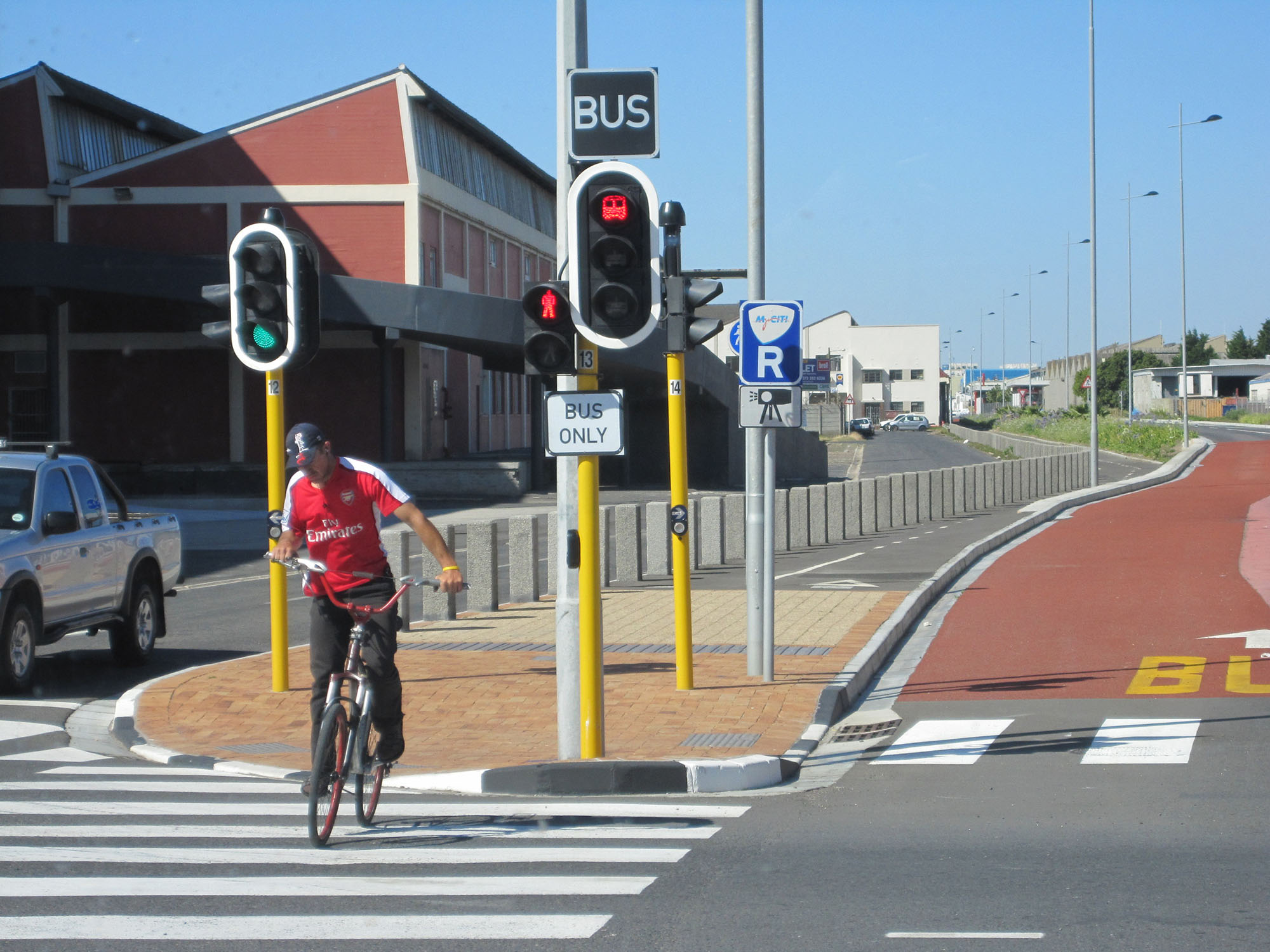 Fig. 23.18 In Cape Town, South Africa, the separator between the busway and the mixed-traffic vehicles acts as a two-way bike lane and an island for pedestrians.